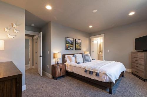 a bedroom with a large bed and a flat screen tv at Modern abode in Central Missoula! in Missoula