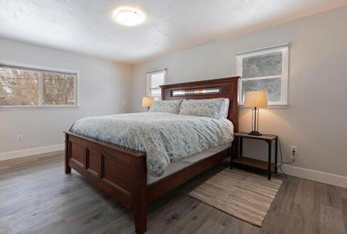 a bedroom with a bed and two windows at Salish Court in Missoula