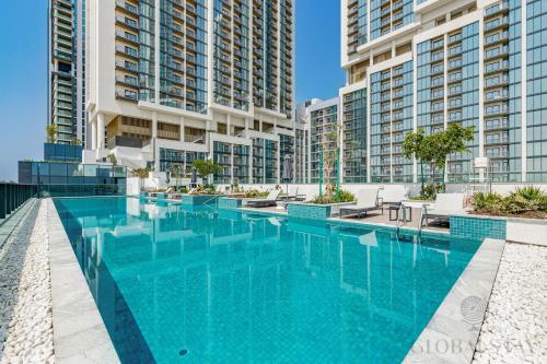 a swimming pool in a building with tall buildings at GlobalStay The Crest Tower C Apartments Dubai in Dubai