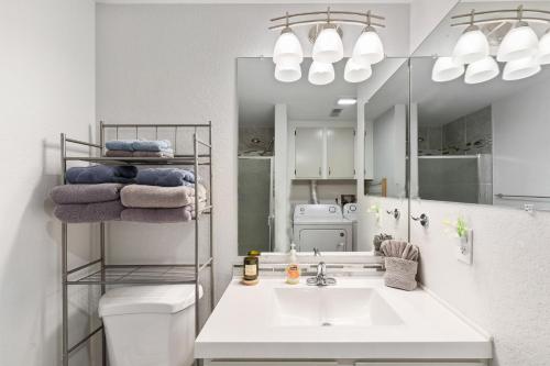 a white bathroom with a sink and a mirror at Close to downtown on Riverfront Park in Missoula