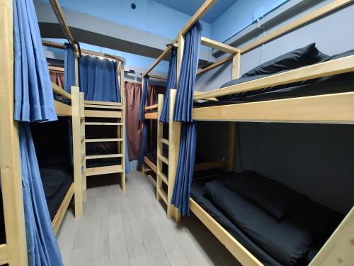 a group of bunk beds in a room at Backstage Party Hostel & Bar in Osaka