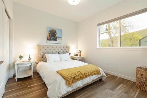 a white bedroom with a bed and a window at The Railway Lofts 201 in Missoula