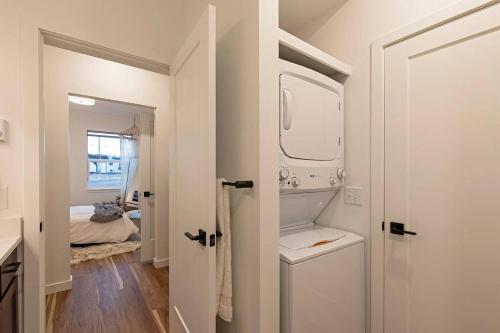 a bathroom with a sink and a washing machine at The Railway Flats 101 in Missoula