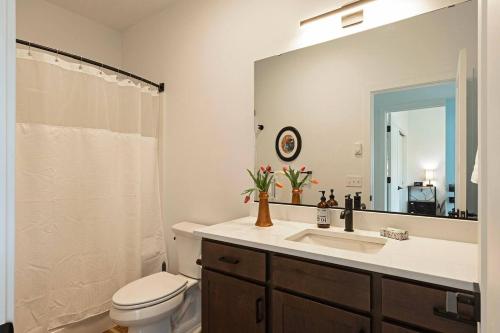 a bathroom with a sink and a toilet and a mirror at The Railway Lofts 202 in Missoula