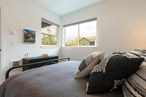 a bedroom with a bed with pillows and a window at The Railway Lofts 202 in Missoula