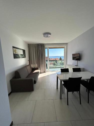 a living room with a couch and a table at Kristal Paris Resort in Novalja