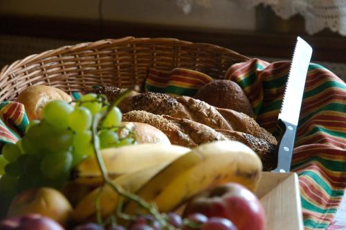 a basket of bread and fruit on a table at Landhaus Greiderer in Kössen