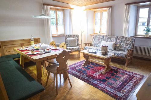 a living room with a table and a couch at Chasa Bugliet in Sent