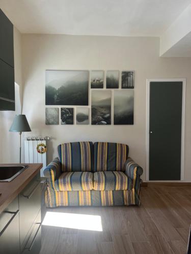 a living room with a couch and pictures on the wall at Victor's House in Pacentro