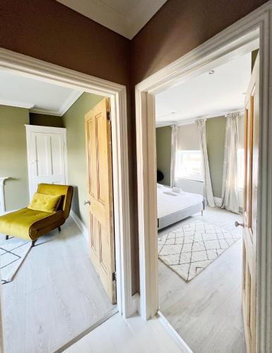 a bedroom with a bed and a mirror at Rodney Retreat, Ramsgate Kent in Haywards Heath