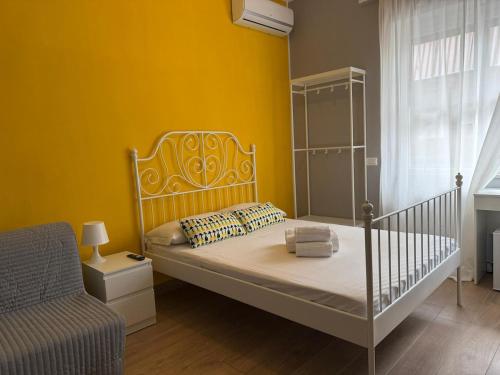 a bedroom with a bed and a chair at B&B Bella Mare Suites - Formia in Formia
