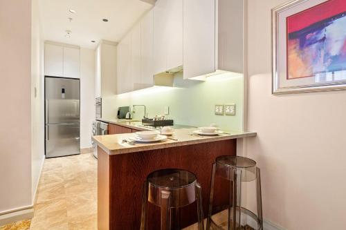 a kitchen with a counter with two bar stools at Taj Hotel 305 by Host Agents in Cape Town