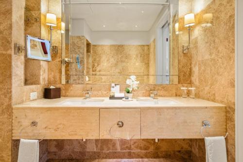 a bathroom with a sink and a mirror at Taj Hotel 305 by Host Agents in Cape Town