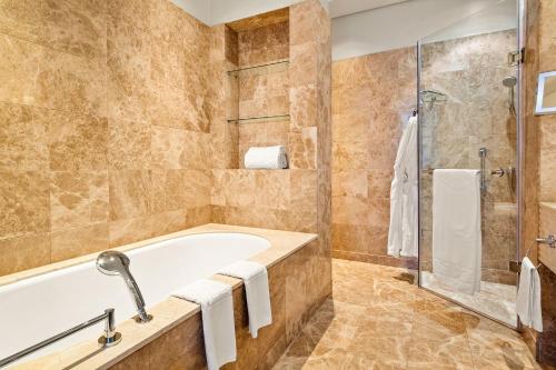 a bathroom with a bath tub and a shower at Taj Hotel 305 by Host Agents in Cape Town