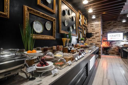 a restaurant with a buffet of food on a counter at Best Western Premier Westlands in Nairobi