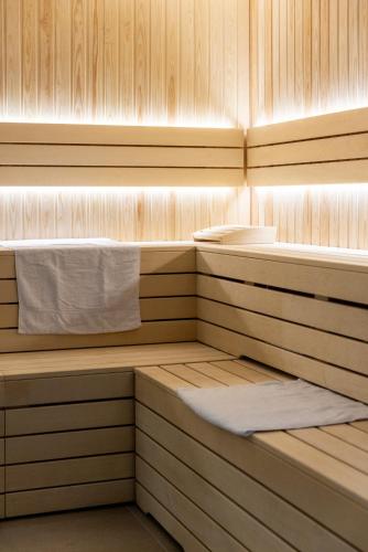 a sauna with two beds and a white towel at Mercure Ax Les Thermes in Ax-les-Thermes
