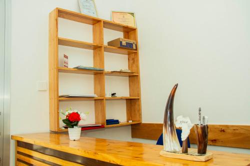 a desk with a book shelf and a wooden table at Maasai Villa in Arusha
