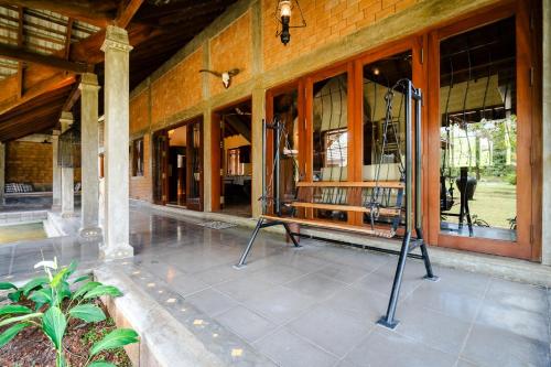a porch of a building with a bench and windows at The Pier House in Panadura