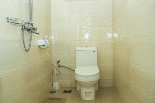 a bathroom with a toilet and a shower at Maasai Villa in Arusha