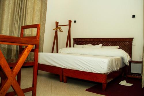 a bedroom with a bed with a wooden frame at Maasai Villa in Arusha
