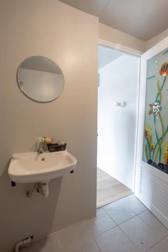 a bathroom with a sink and a mirror at Father Garden Inthanon in Ban Na Yang
