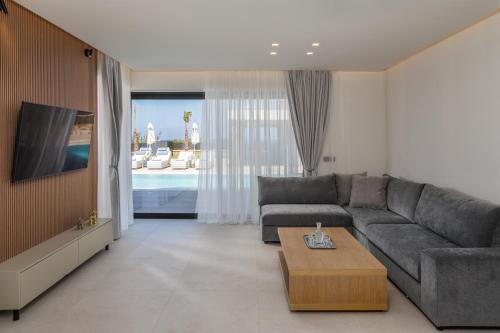 a living room with a couch and a coffee table at Divel Luxury Villas with heated pools, by Estia in Anissaras
