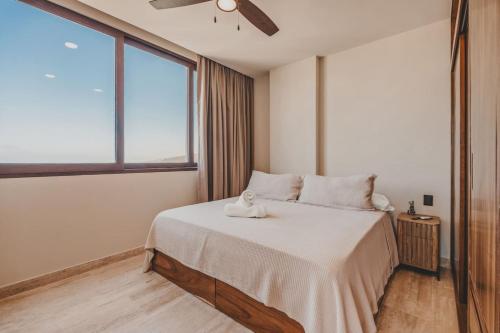 a bedroom with a bed with a stuffed animal on it at Sayulita Serenity in Sayulita