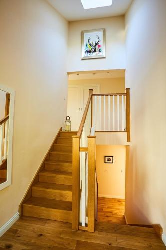 a hallway with a staircase in a house at Chapelhill in Helensburgh
