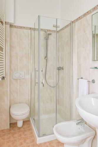 a bathroom with a shower and a toilet and a sink at Locanda alla Chiesa in Lazise