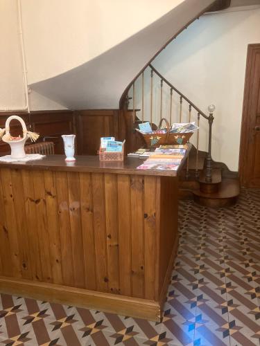 a room with a wooden counter with a staircase at Chez Bilhouet in Segonzac