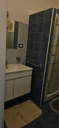 a bathroom with a sink and a mirror at Appartamento In Centro in Iglesias