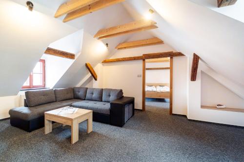 a living room with a couch and a table at Pivovar Prachatice in Prachatice