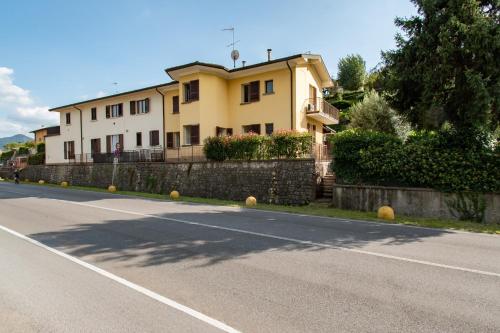 a large yellow house on the side of a road at Cascina Ca' Bark in Clusane sul Lago