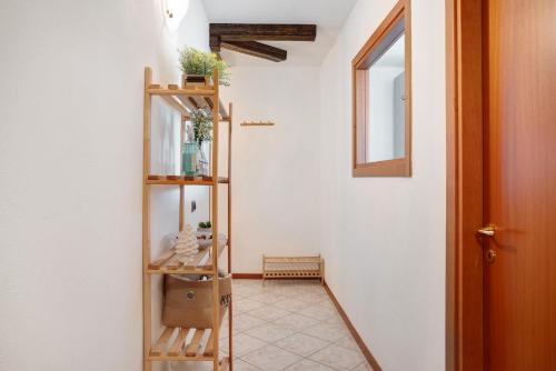 a hallway with a wooden shelf with plants on it at La Terrazza Panoramica in San Sebastiano