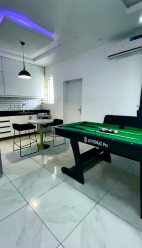a room with a ping pong table in the middle at Fort Fountain Apartments in Abuja