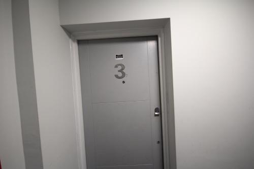 an elevator door with the number three on it at Holden Court Apartments - Apt 3 in West Drayton