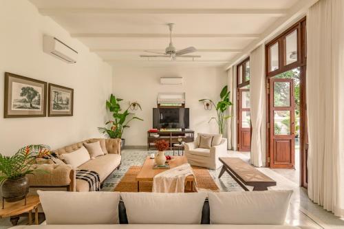 a living room with a couch and a table at La Morella - 4BHK Luxury Villa in Assagao with Private Pool, Garden, Balcony, Caretaker, Kitchen, Genset Backup, Security in Assagao