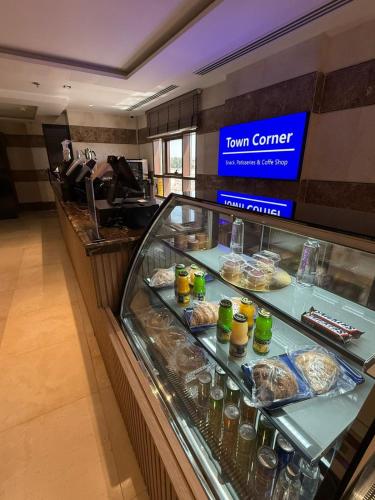 a food counter in a restaurant with food on display at فندق هيل Hill Hotel in Al Madinah