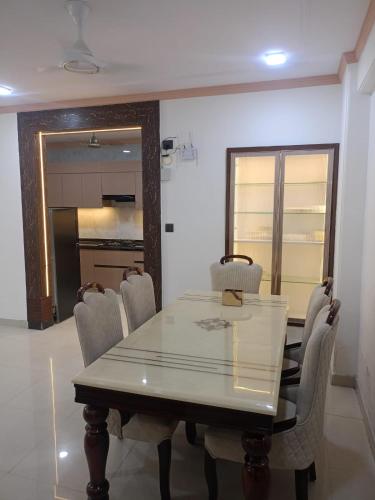 a dining room with a table and chairs at TANISH HOME STAY 3 bhk APARTMENT in Jāmb