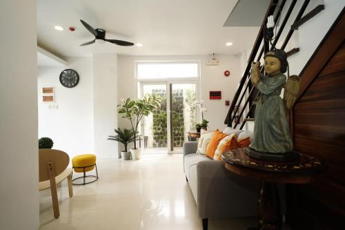 a living room with a statue of an angel on a couch at 20 Boeing Apt in Manila