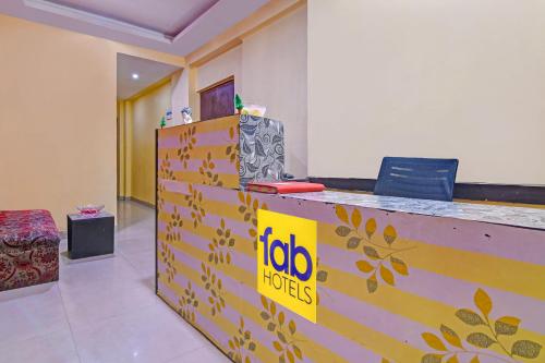 a reception desk in a room with aida foods sign on it at FabHotel Swagatam in Kolkata