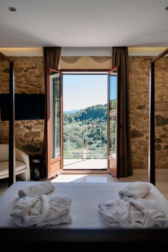 a bedroom with a bed and a large window at YOUNG Hotels Denia in La Vall de Laguar
