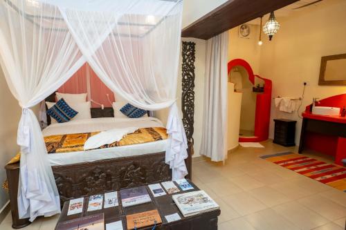 a bedroom with a bed with a canopy at Jafferji House in Zanzibar City