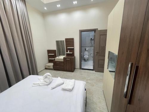 a bedroom with a bed with white towels on it at Grand Luxury Apartments - Downtown Cairo in Cairo
