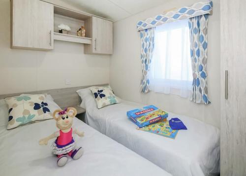 a small room with two beds and a toy mouse sitting on the bed at Springhouse Country Park in Slaley
