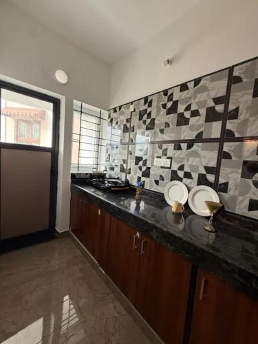 a bathroom with a counter with two sinks in it at The Cozy Cranny in Chennai