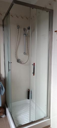 a shower with a glass enclosure in a bathroom at Appartamento in Garbagnate Milanese