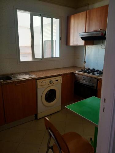 a kitchen with a washing machine and a stove at nice apartment in Tunis