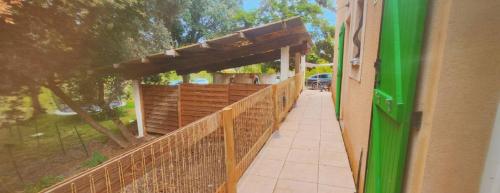 a building with a wooden fence and a walkway at A 10 min de la cité Médiévale de Carcassonne in Alairac