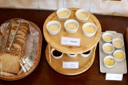 a tray of food with eggs and bread on a table at Pousada Recanto da Ladeira in Paraty
